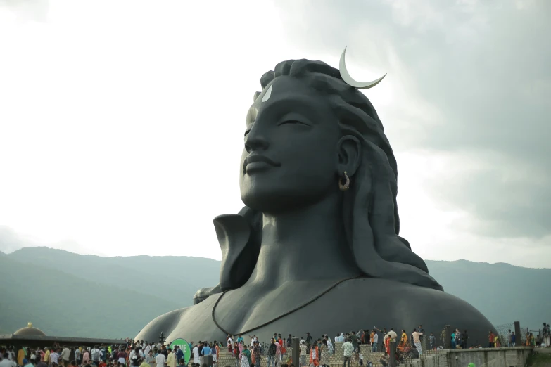 a large statue surrounded by a crowd of people