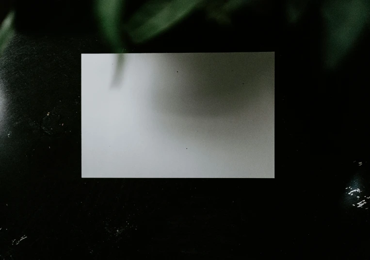a piece of paper on a surface with some light on it
