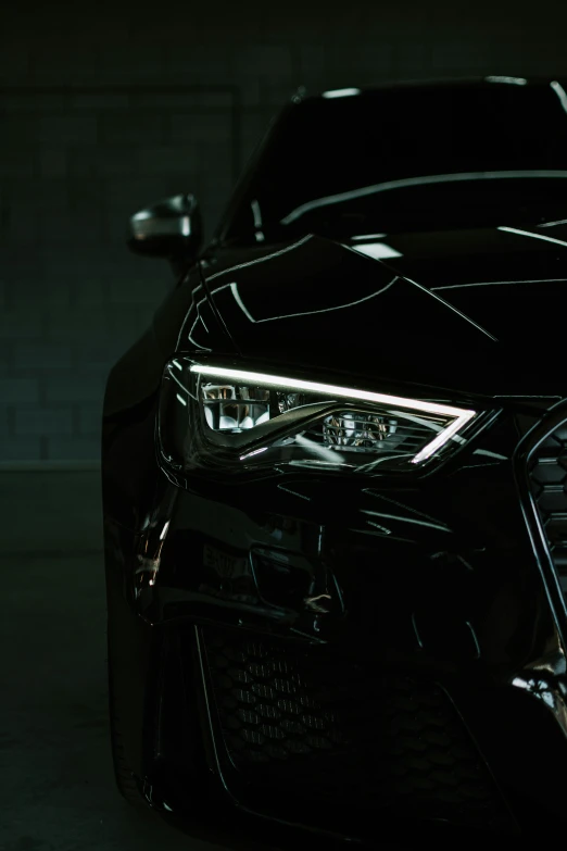 a car parked inside a dark garage with some lighting