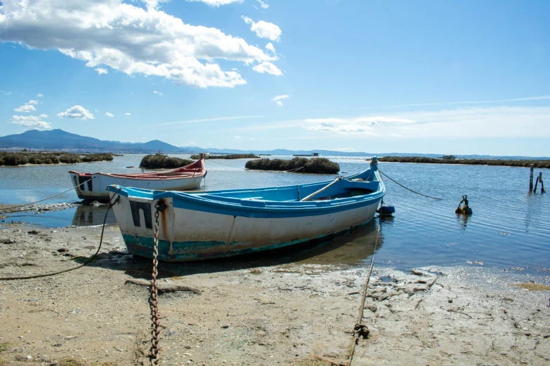 two boats that are tied to the shore