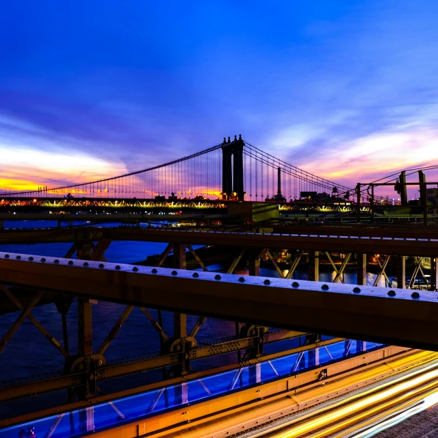 a bridge with cars passing by it during the night time