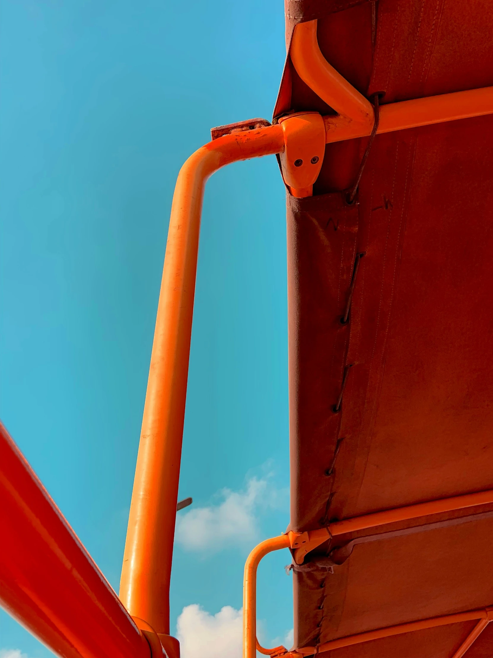 a couple of large orange metal poles next to each other