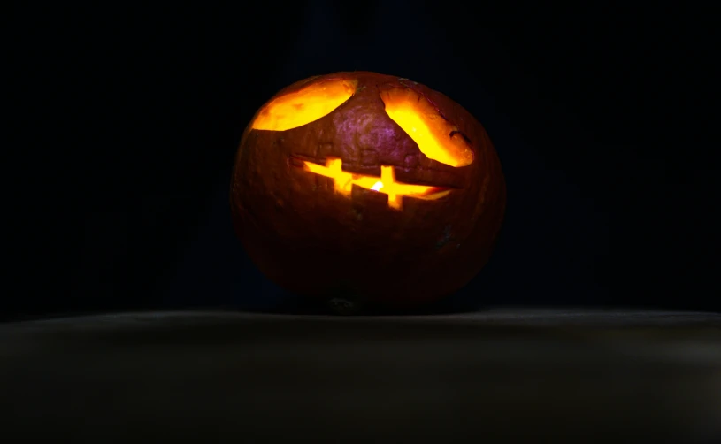 a scary pumpkin with faces carved in it