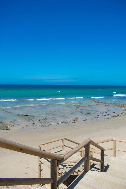 the beach is clean and clear but the water is blue