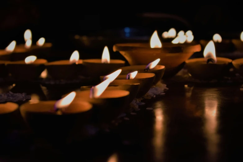 many candles burning on a table at night