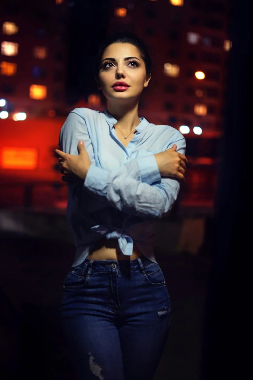 the woman is posing for a po while wearing jeans