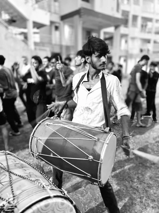 man with beat drums on street in city