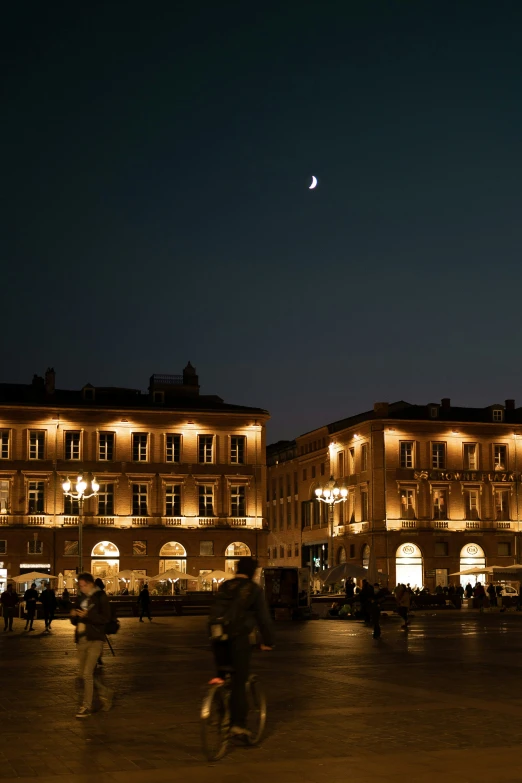 a building on a city street at night with people and bikes