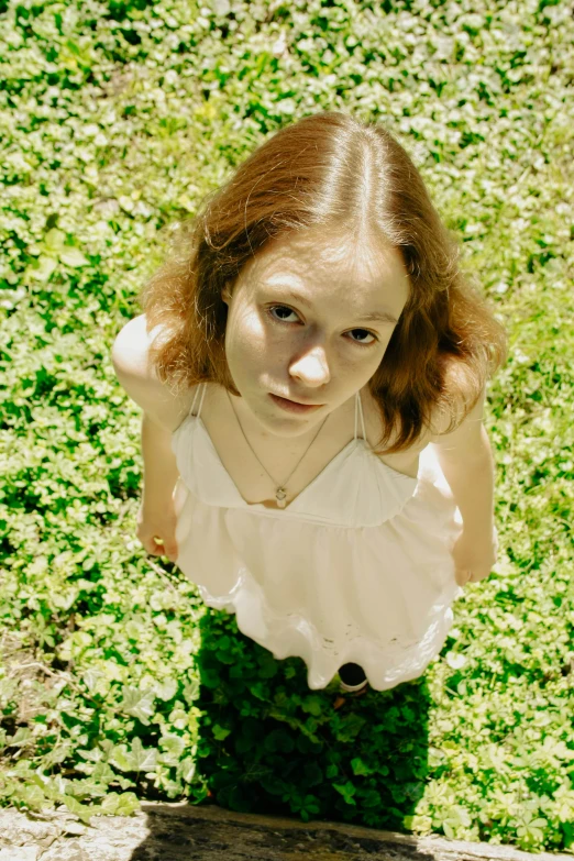 a  poses in a white dress