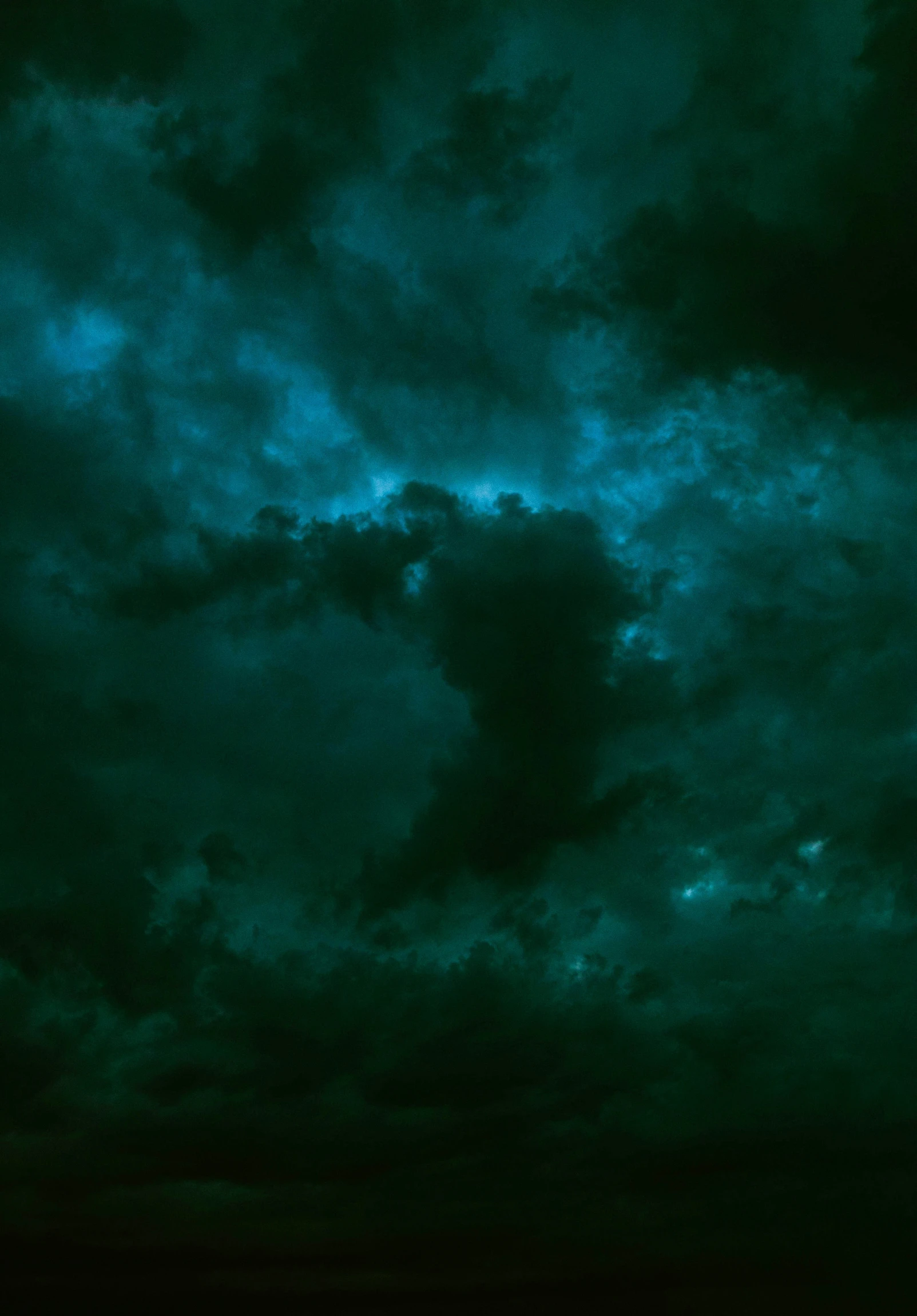 dark clouds over grass with bright green lights