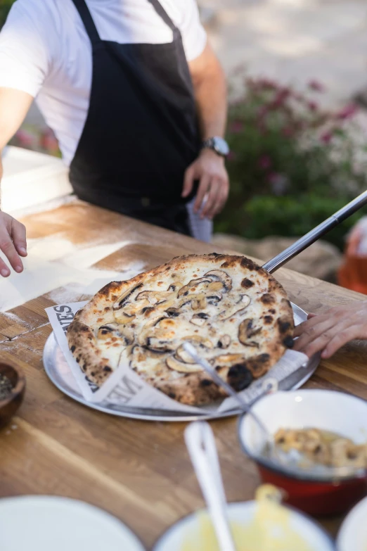 a pizza sitting on top of a wooden table