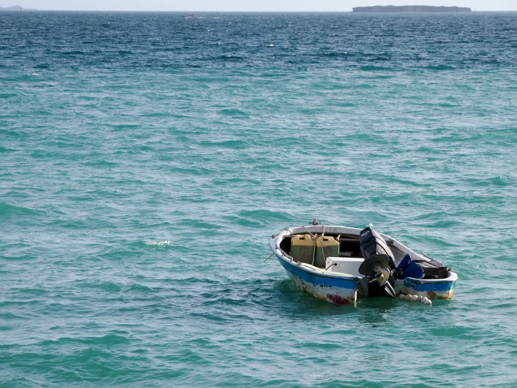 the boat is floating in the blue waters