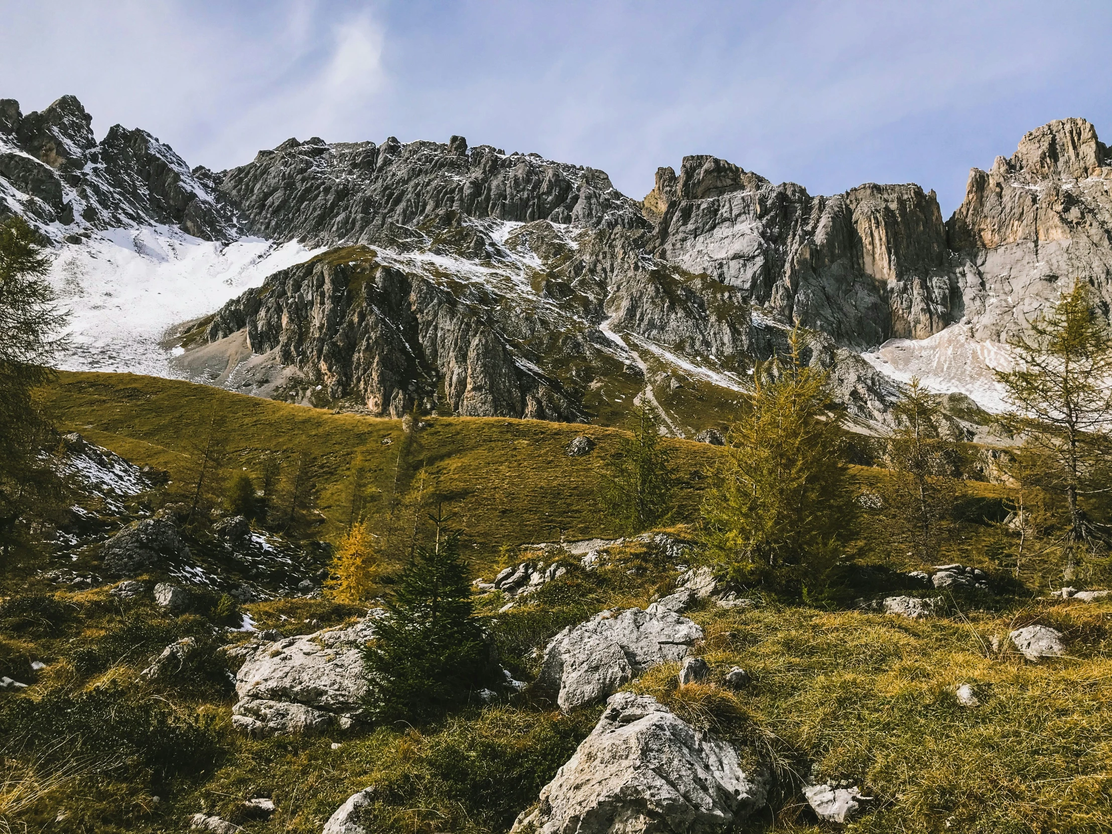 a mountain side with a very large rock formation