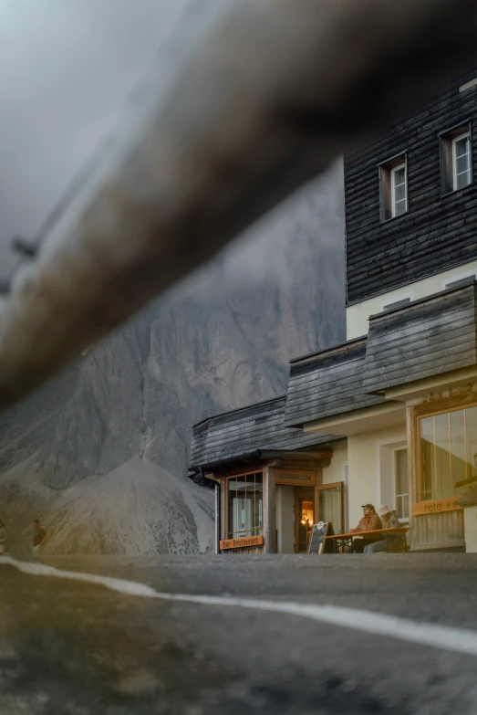 a po looking down at a building with a tall mountain in the background