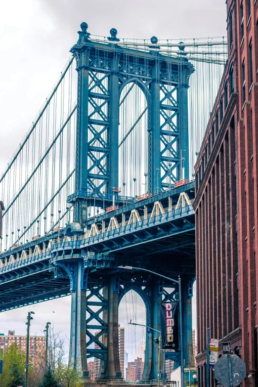 a large bridge going over a river filled with tall buildings