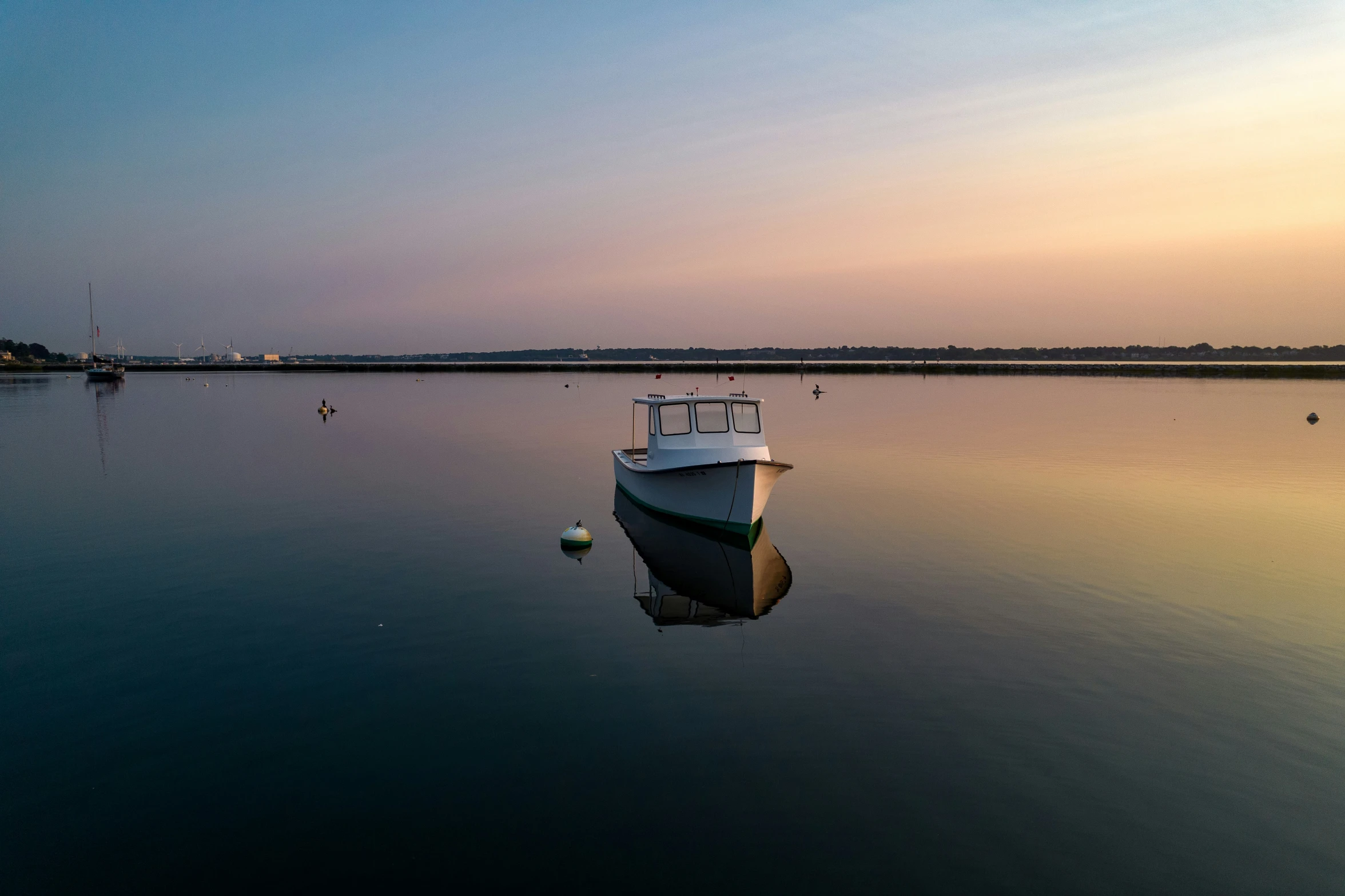 the boat is sitting in the water with other boats