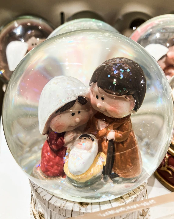 a snow globe with two small figurines in it