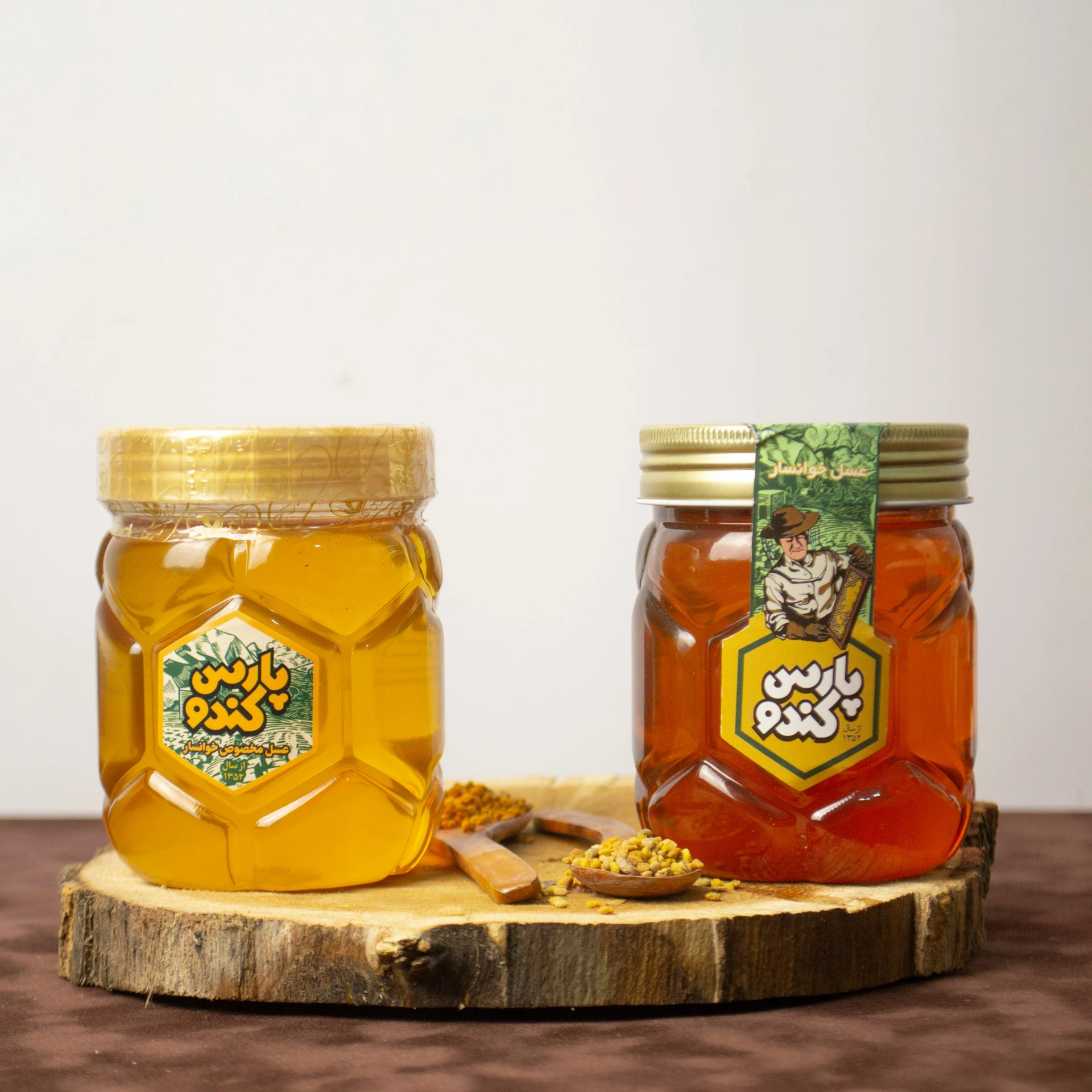 jars of bee pollen sit on top of a wooden board