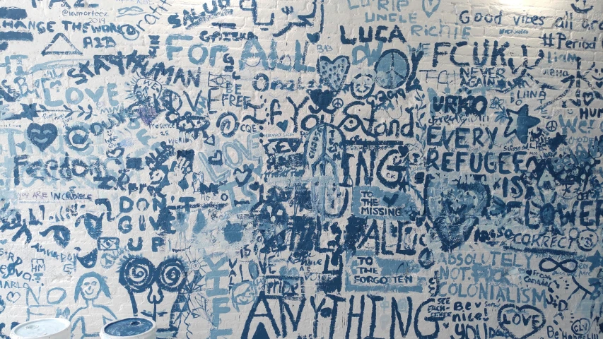 a blue and white wall with many writing on it