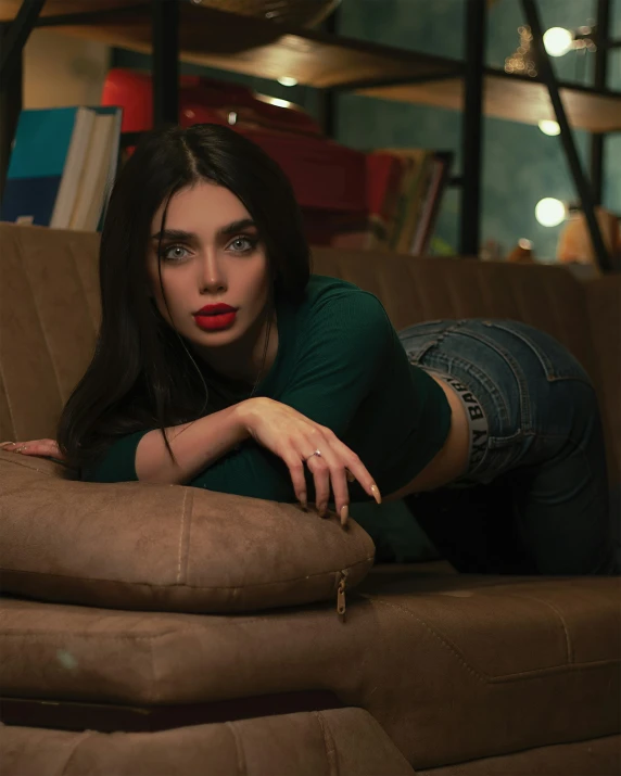 a beautiful woman lying down on top of a couch