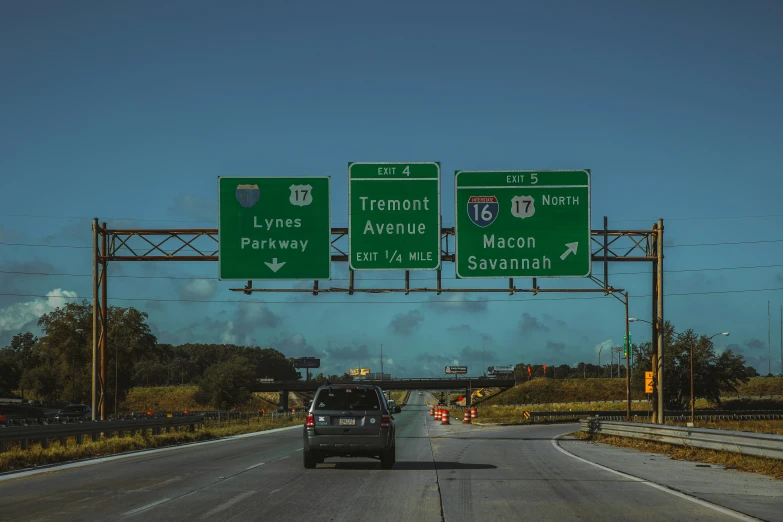 there are three large highway signs above the truck