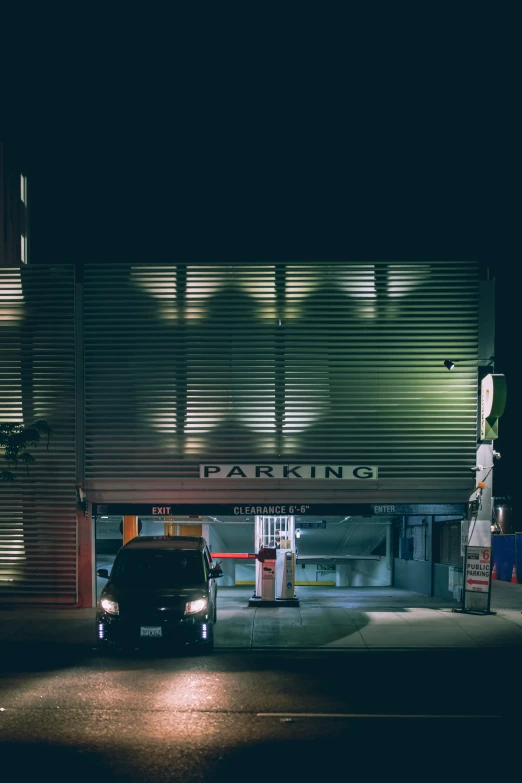 a car is parked by a building with no lights