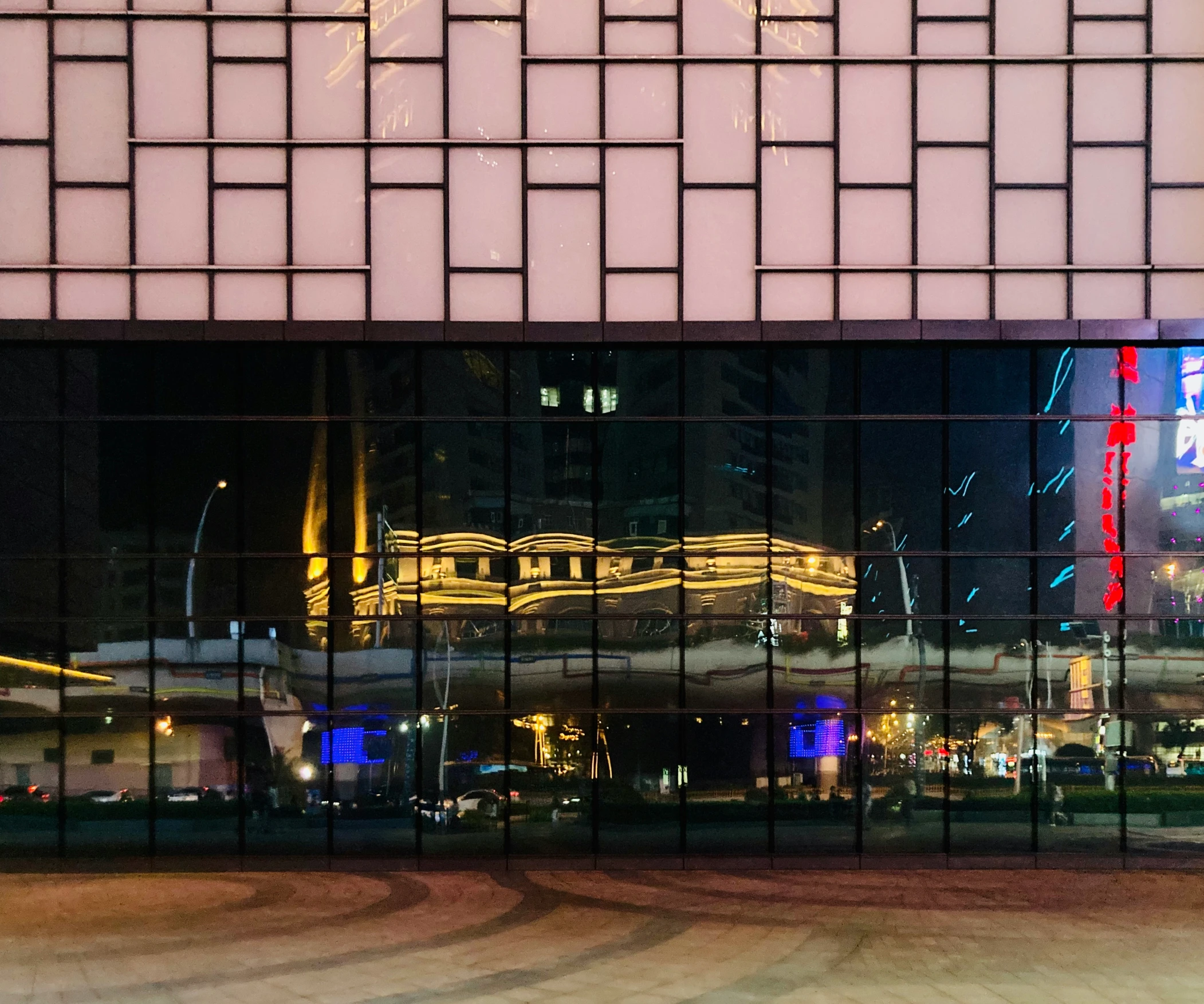 a large building has a window with a reflection in it