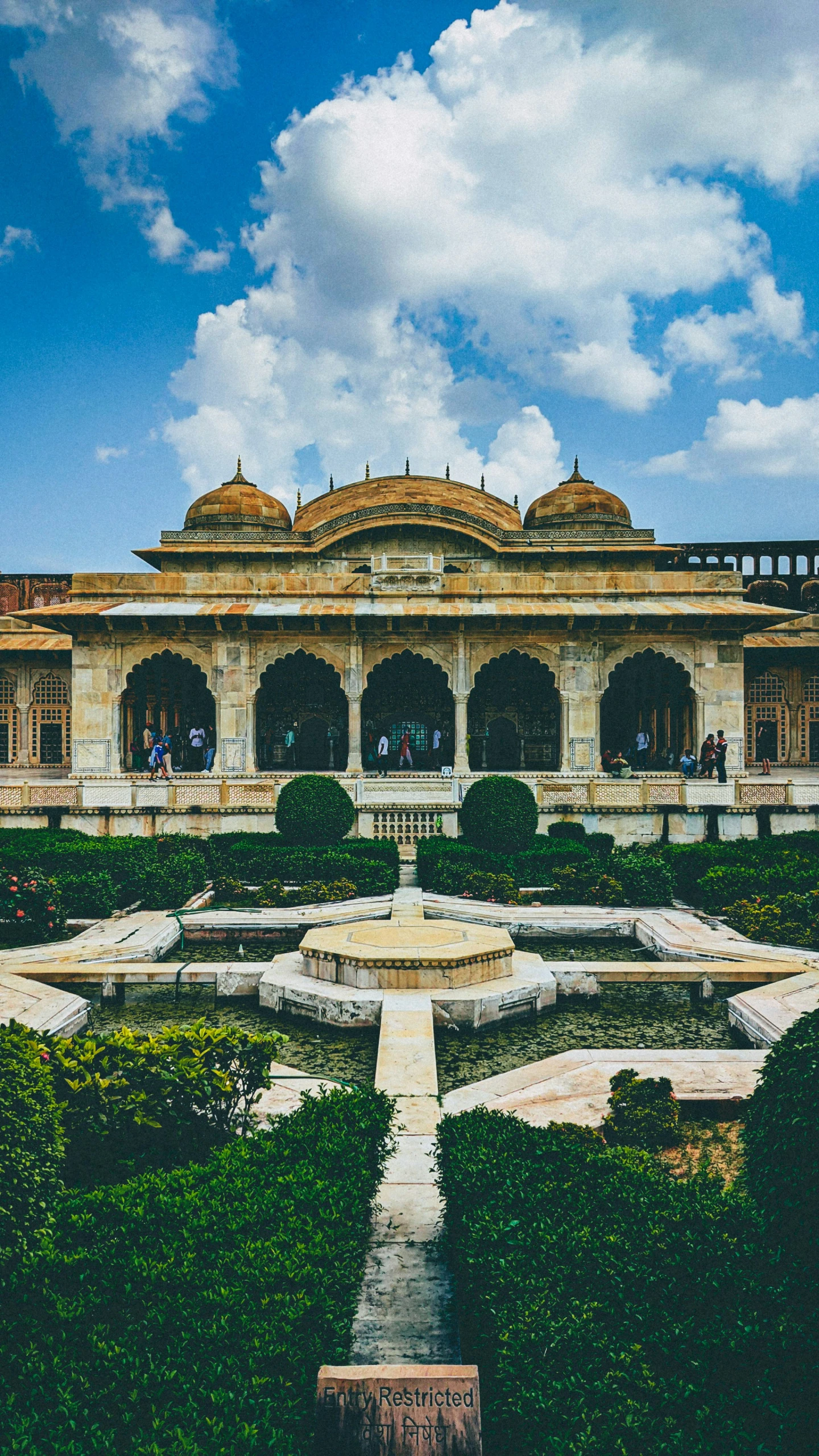 the ornate garden surrounding the building has many hedges