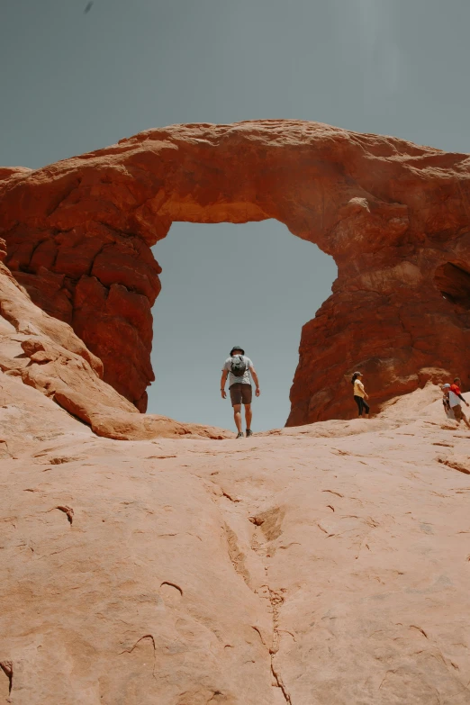 a person on top of some rocks on a beach