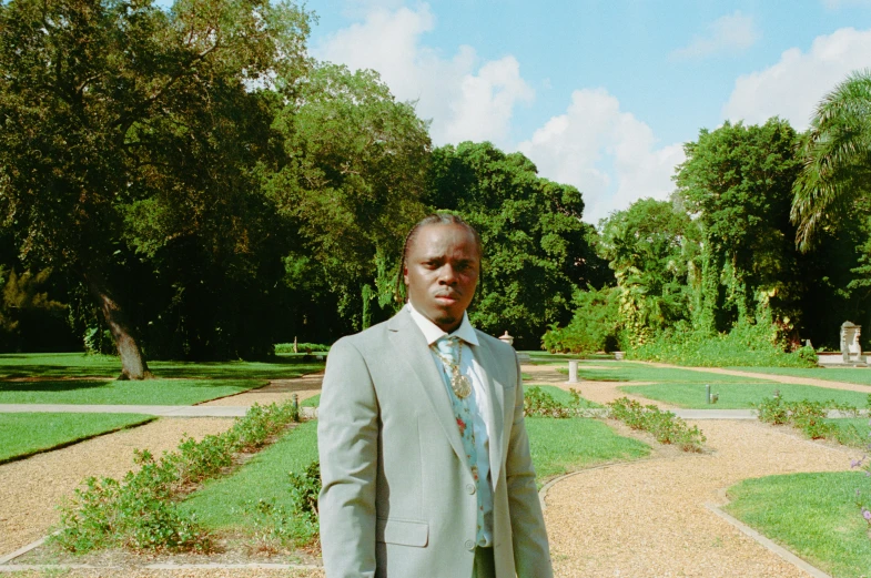 a man stands outside of a formal park