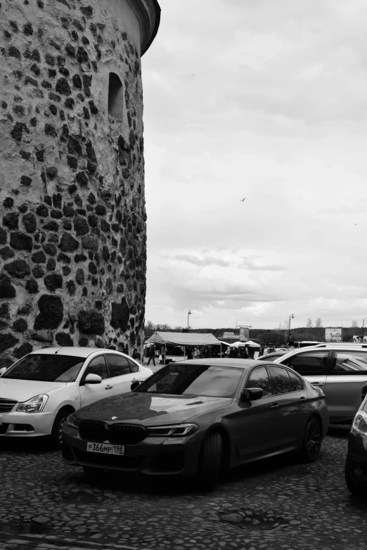 a large stone structure sitting next to several cars