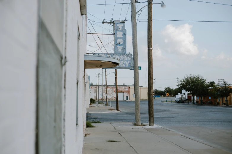 this is the corner of a street with a building and power lines