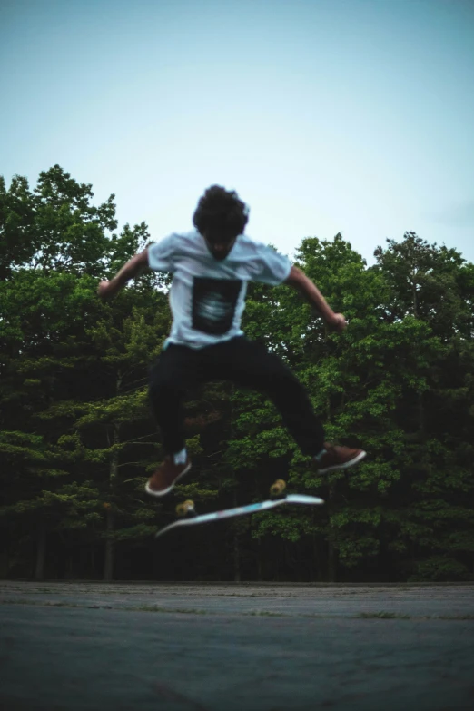 a boy jumping high on a skateboard in the air