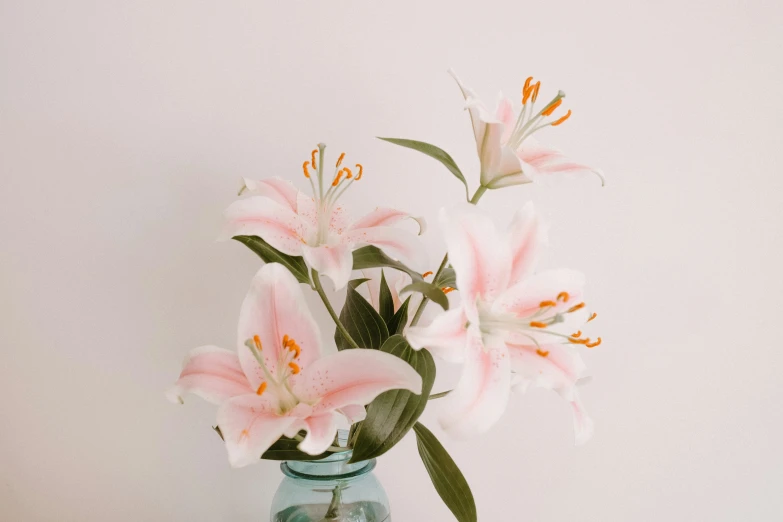 a vase with some flowers inside on the table