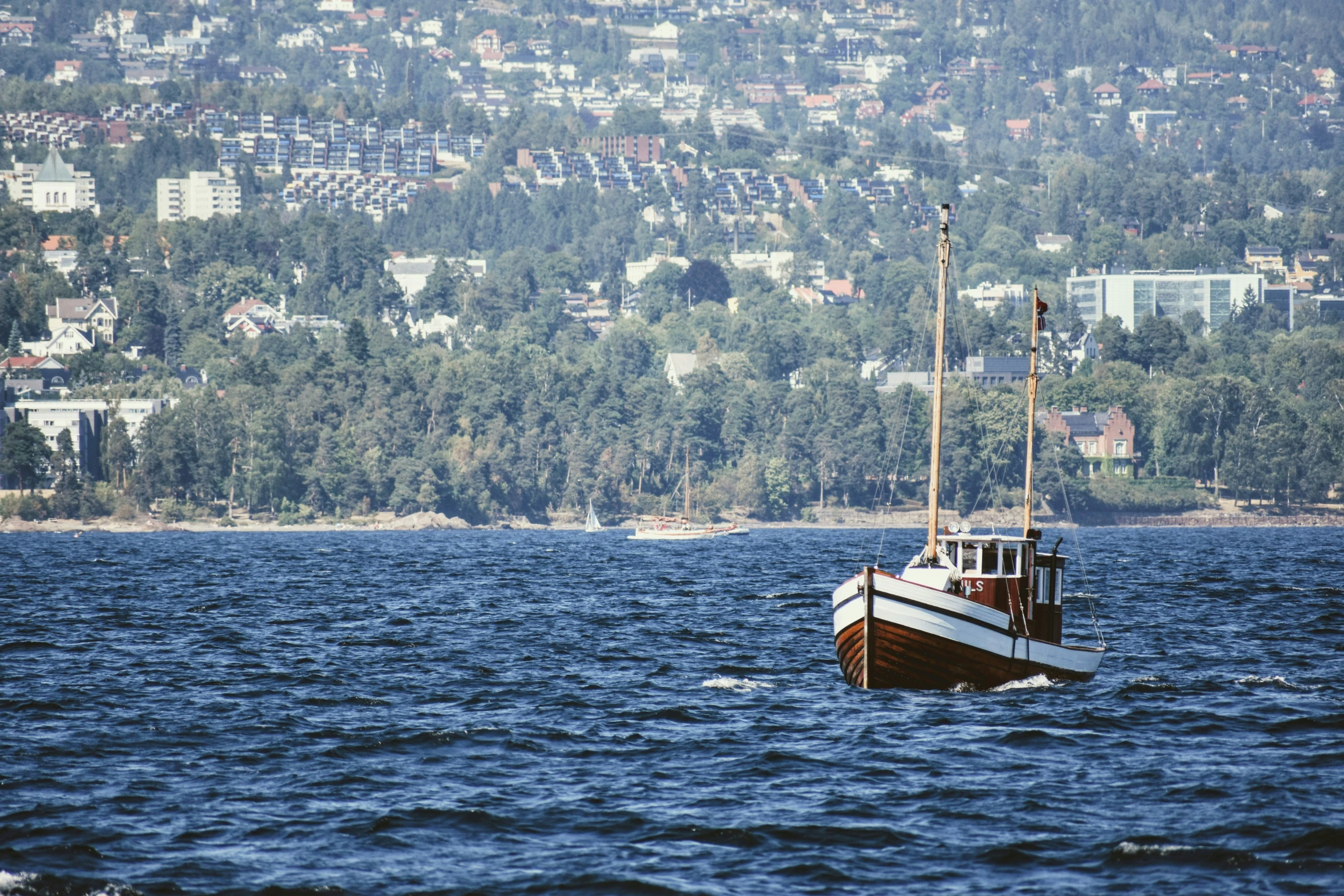 an old wooden boat is out in the water