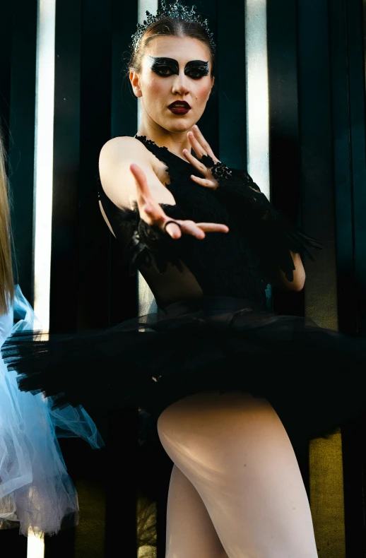 a young woman poses for a picture wearing black and white clothing