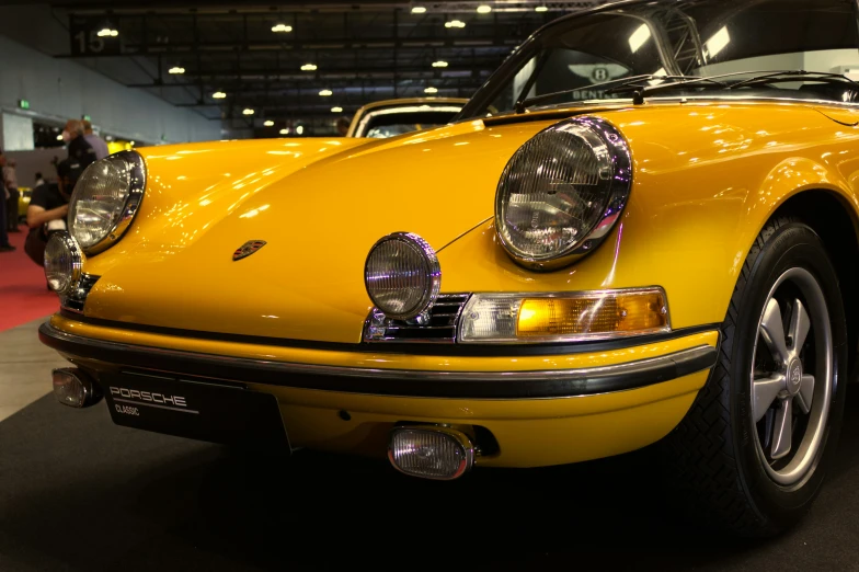 a bright yellow car with the hood up