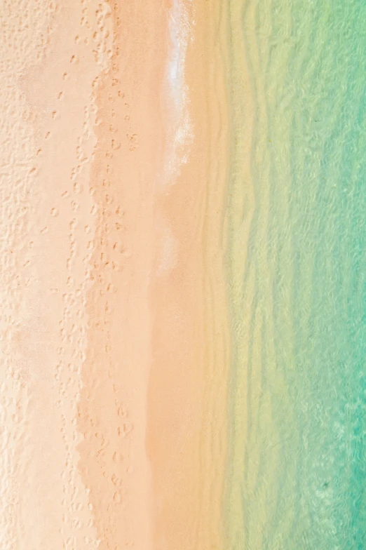 a beach scene from above showing turquoise water and white sand