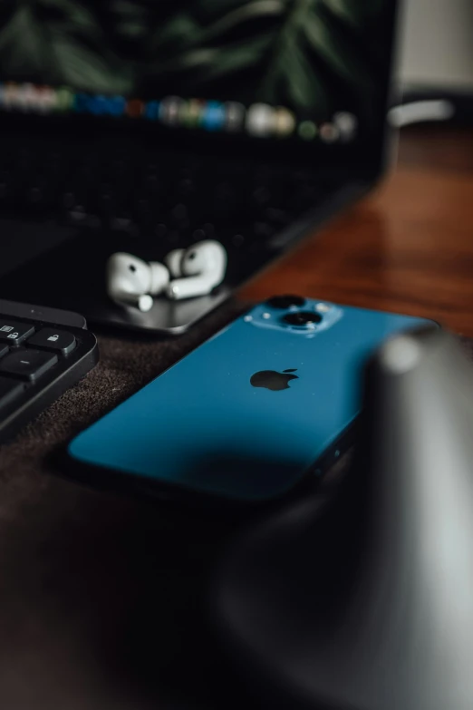 a blue iphone sits next to a keyboard and mouse