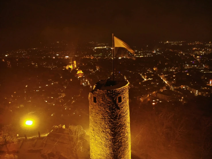 the old tower is lit up in the dark night