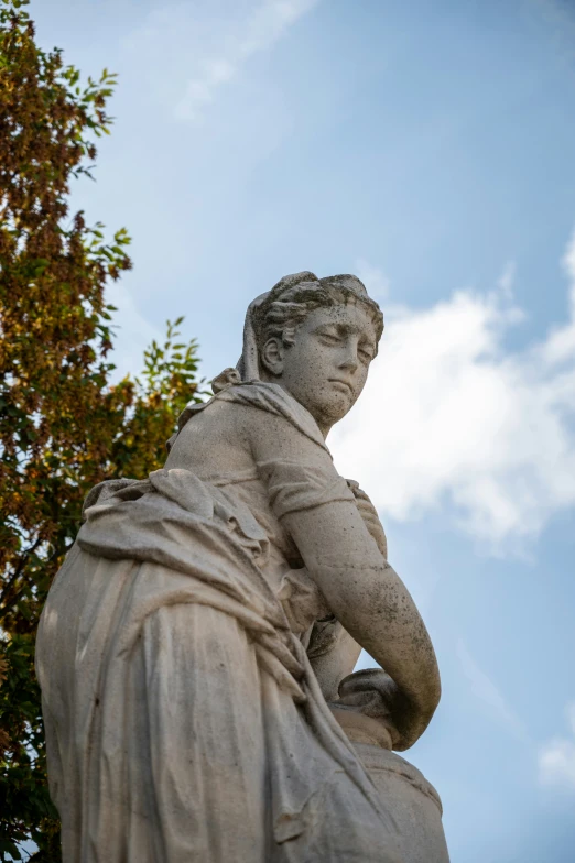 a statue that is standing near trees