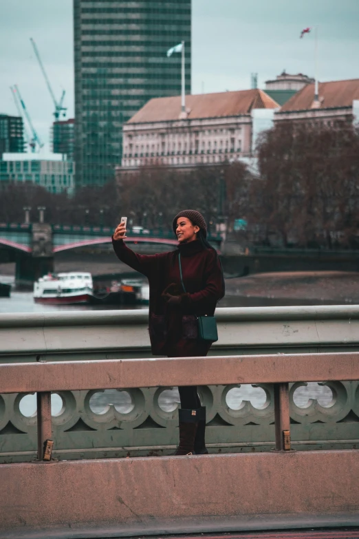 a woman with a cell phone taking a selfie