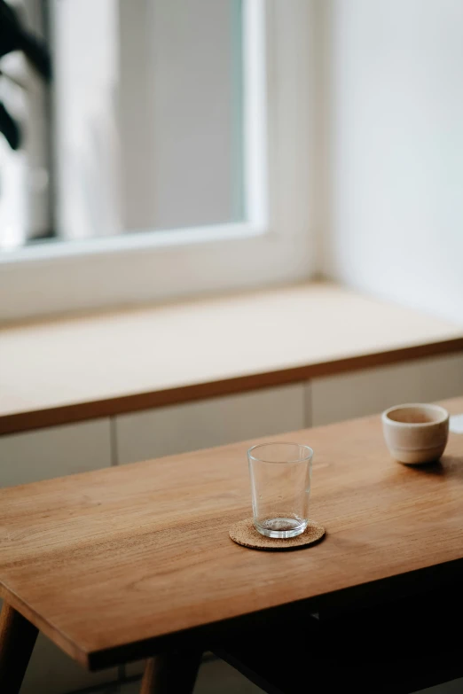 two empty bowls sit on a wood table