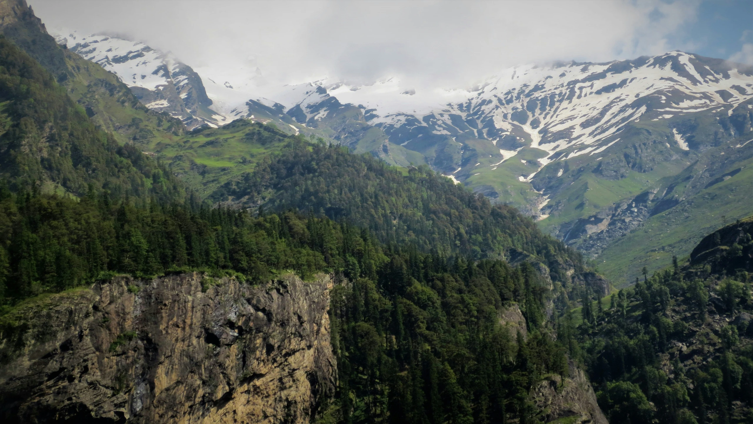 snow covered mountains are seen in the distance