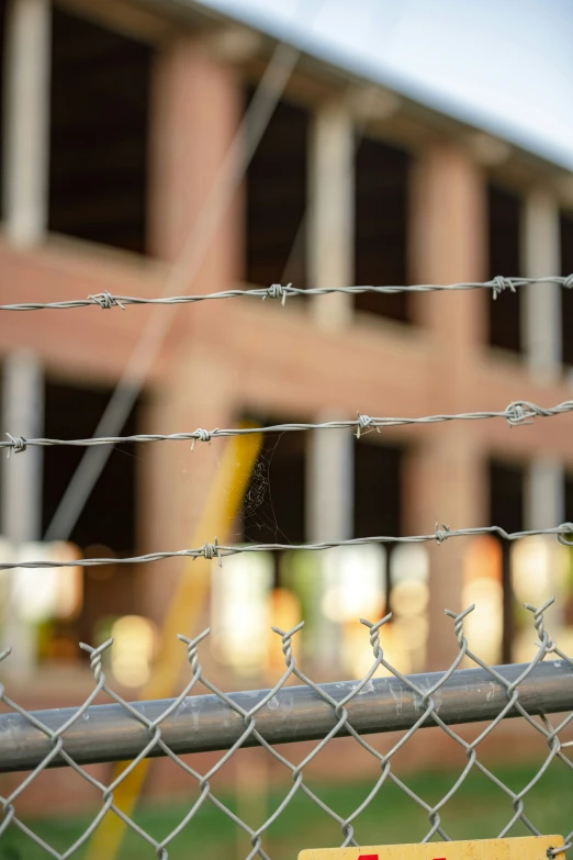 a stop sign behind a barbwire fence