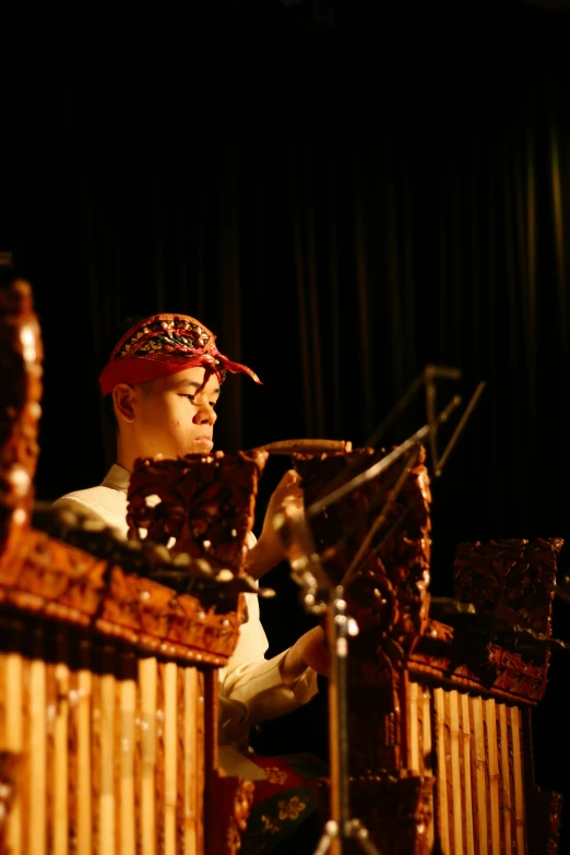a man with a bandana on holding musical instruments