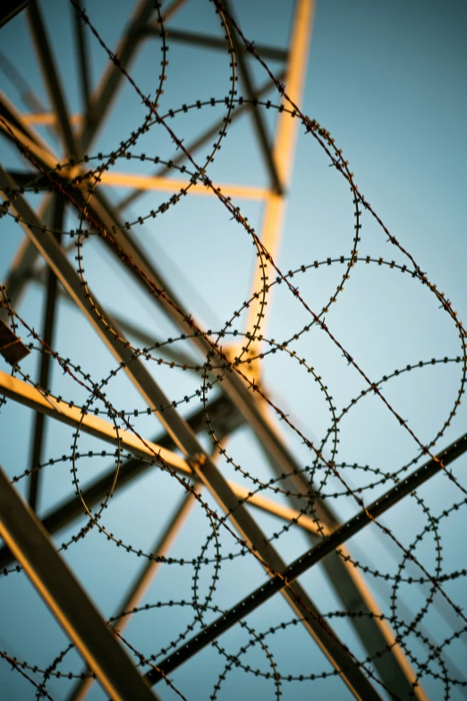 a metal fence with razor wires and razors on top