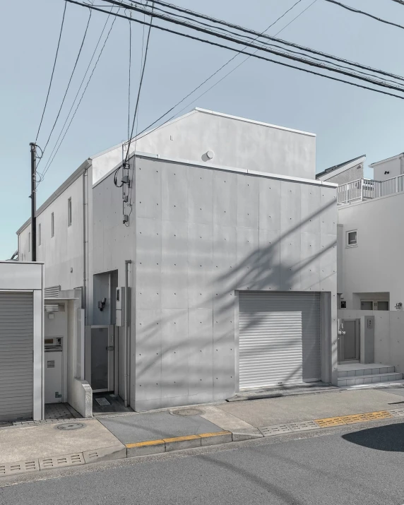 an industrial building on a corner with lots of garage doors