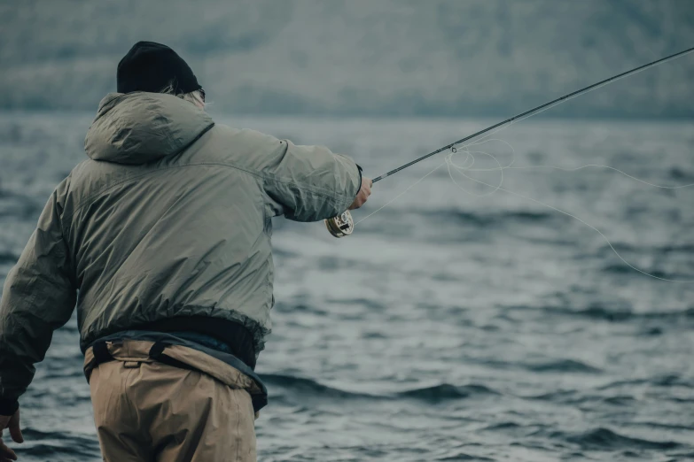 a person fishing on a very cold day