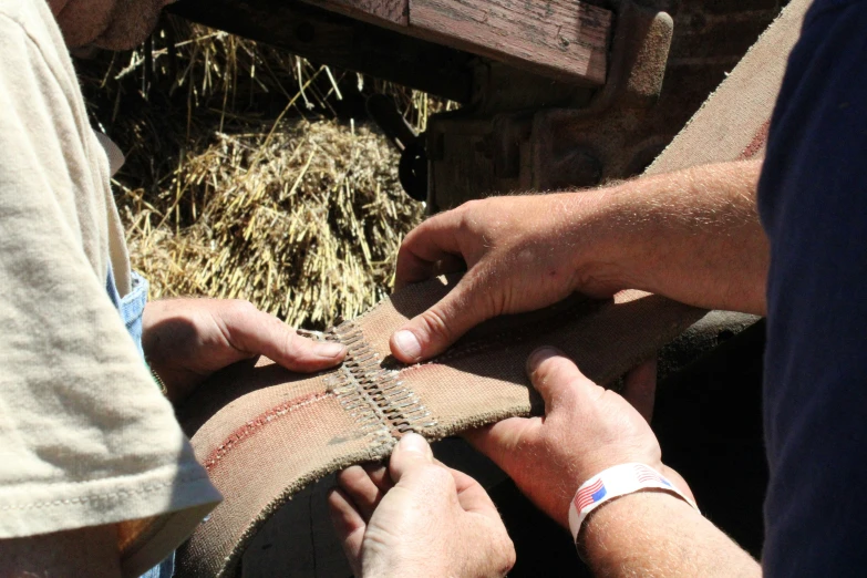 a man is using a piece of cloth to put together